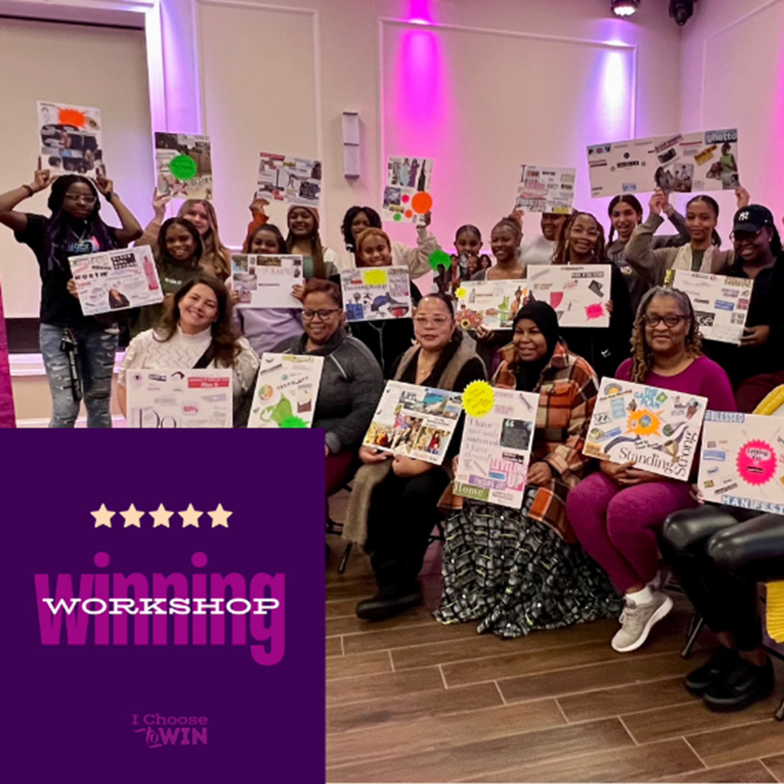 A group of people pose for a photo, with adults seated in the front row and older children and young adults standing in two rows behind them holding up handmade signs and posters. A purple logo sits in the foreground, reading 